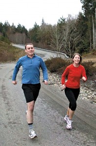 Bruce Stobie and his sister, Melissa Dunning, do a training run in preparation for Saturday’s Yakima River Canyon Marathon, with each holding one end of a strap that helps guide Stobie, who is blind. (Photo courtesy of Ed Dunning)